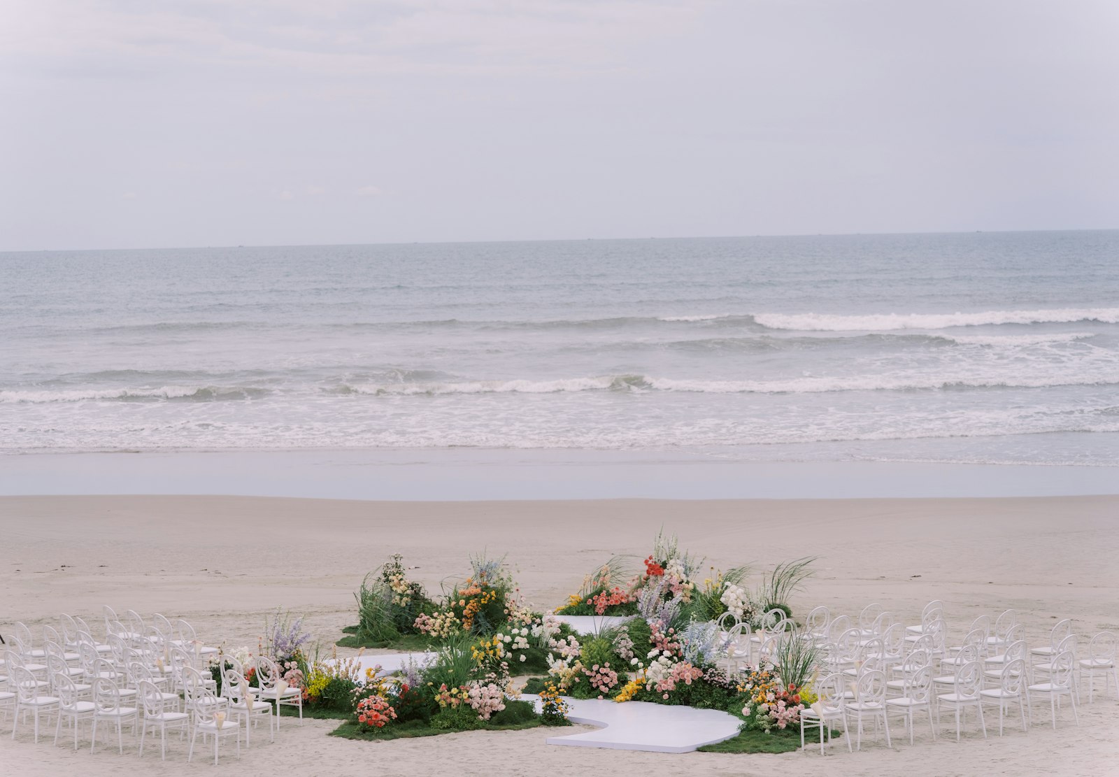 A beach wedding ceremony is set up.