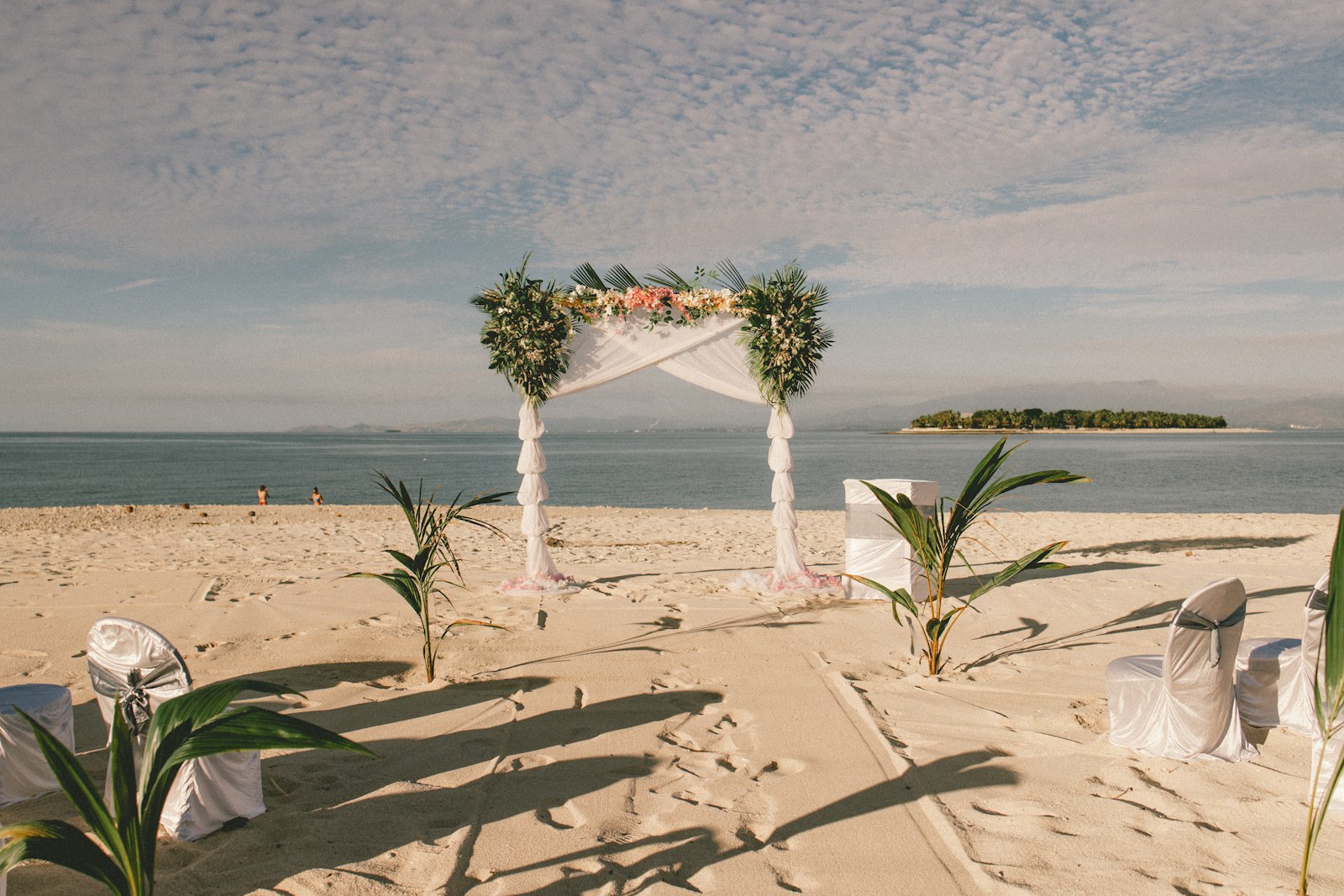 a wedding setup on the beach with a view of the ocean