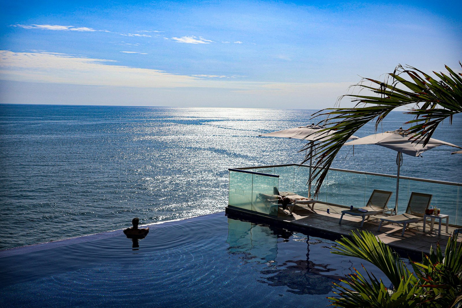 A large swimming pool next to the ocean