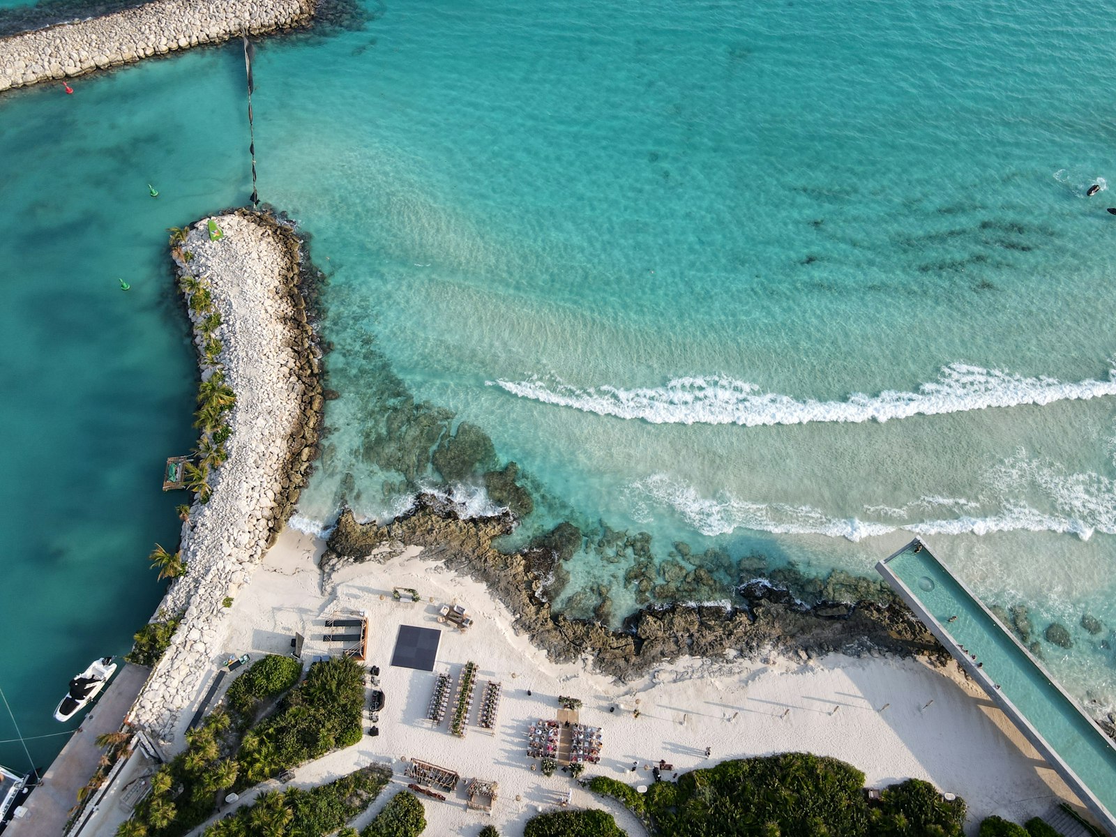 Aerial view of a rocky coastline with turquoise water.