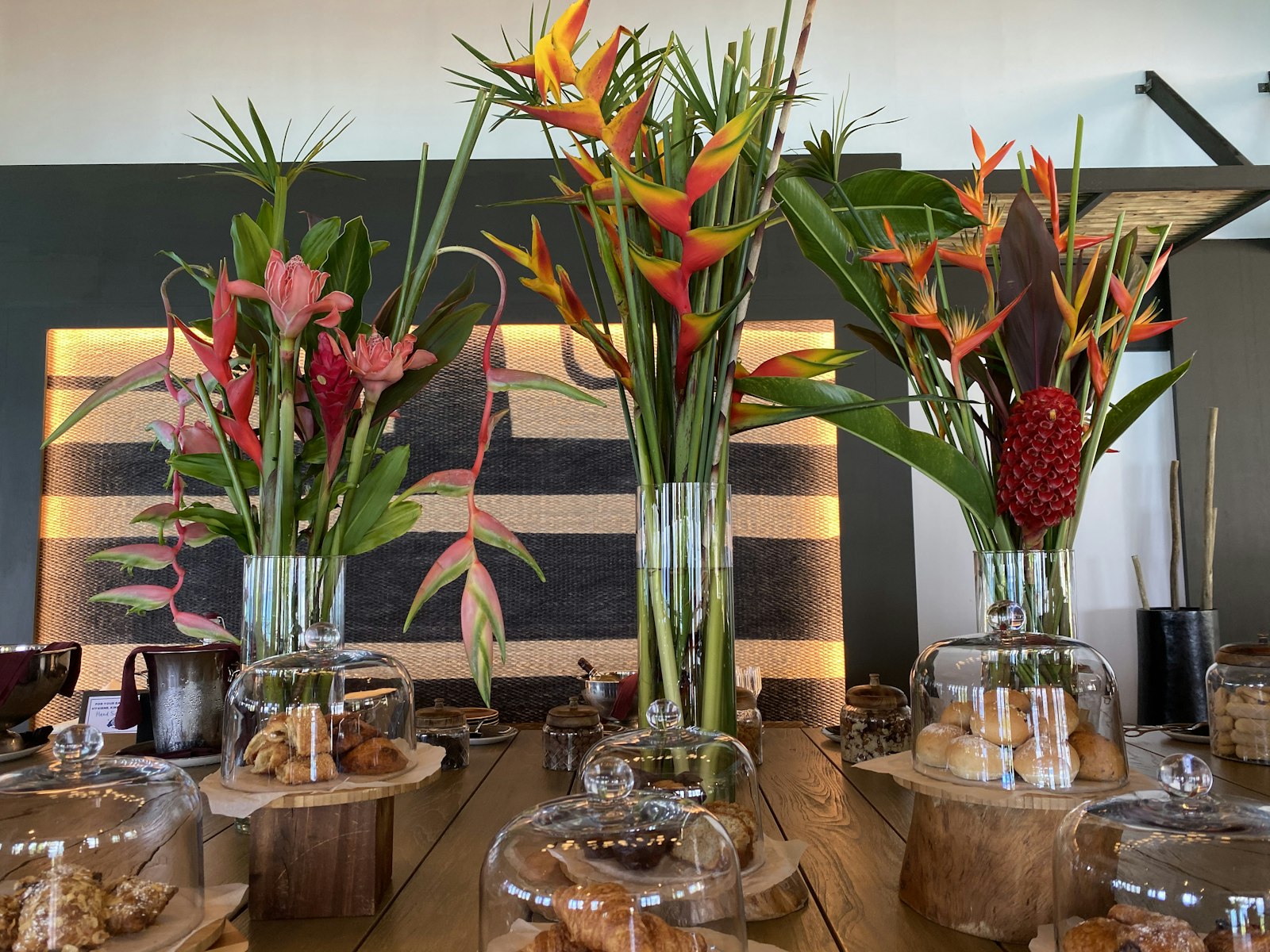 a wooden table topped with vases filled with flowers